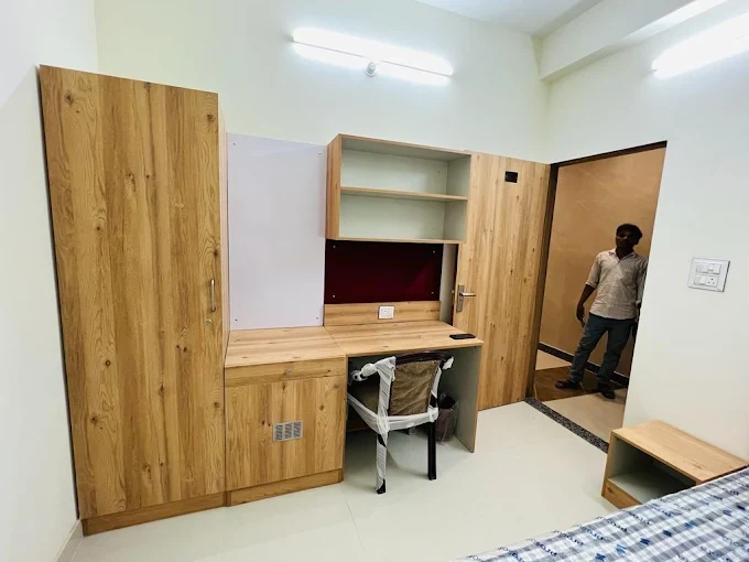 Study table and wardrobe setup in boys hostel room